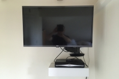 Flat screen TV mounting and remote draw unit